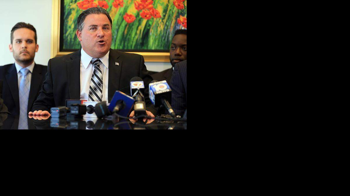 
Suspended City of Miami Lakes Mayor Michael Pizzi, flanked by members of his legal team, Anthony Gonzalez, left, and Michael Davis, during an announcement last month that would sue to take to compel Florida Gov. Rick Scott to rescind Pizzi's suspension as Miami Lakes mayor. Pizzi was acquitted by a jury of all federal charges against him of accepting payoffs during an undercover FBI sting last year. .
