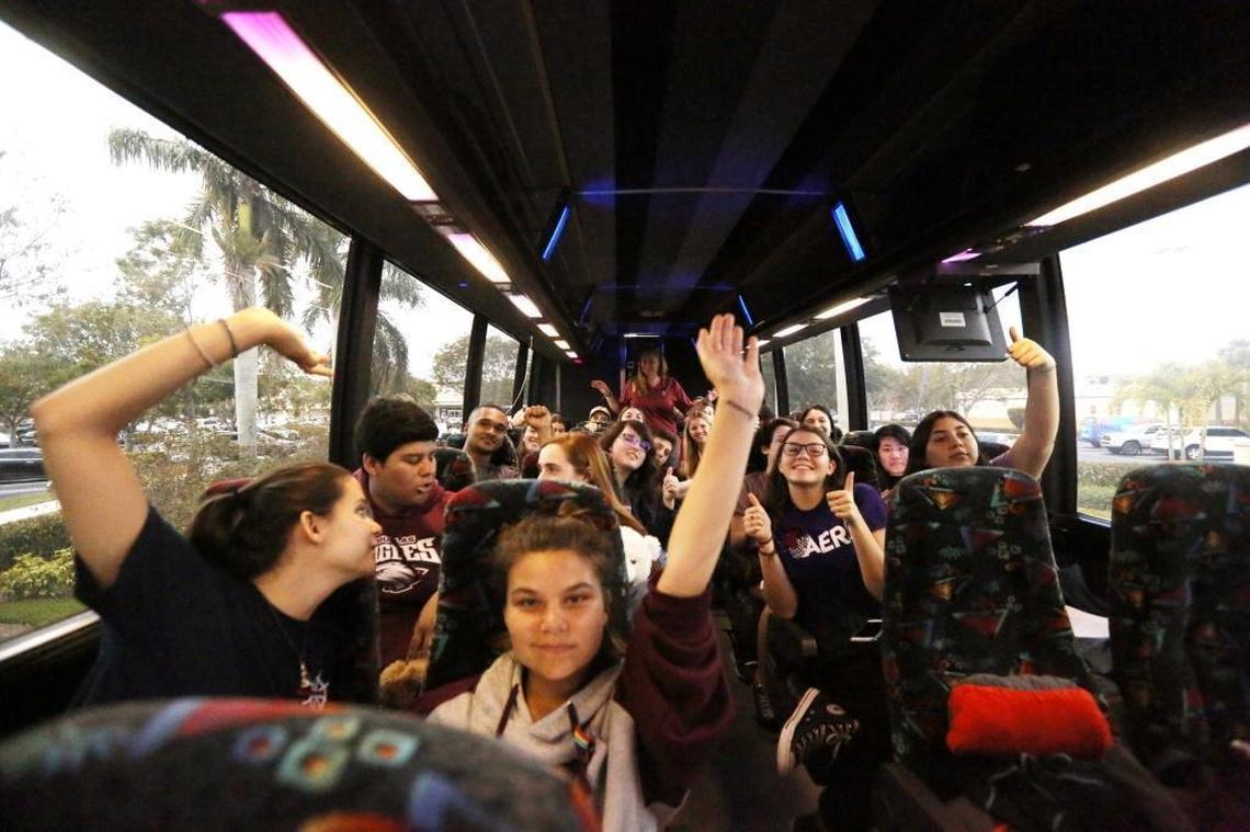 Marjory Stoneman Douglas High School students Julia Salomone, 18, and sister Lindsey, 15, celebrate with other students as their bus leaves Coral Springs bound for Tallahassee on Tuesday, Feb. 20, 2018, to demand stronger gun control.