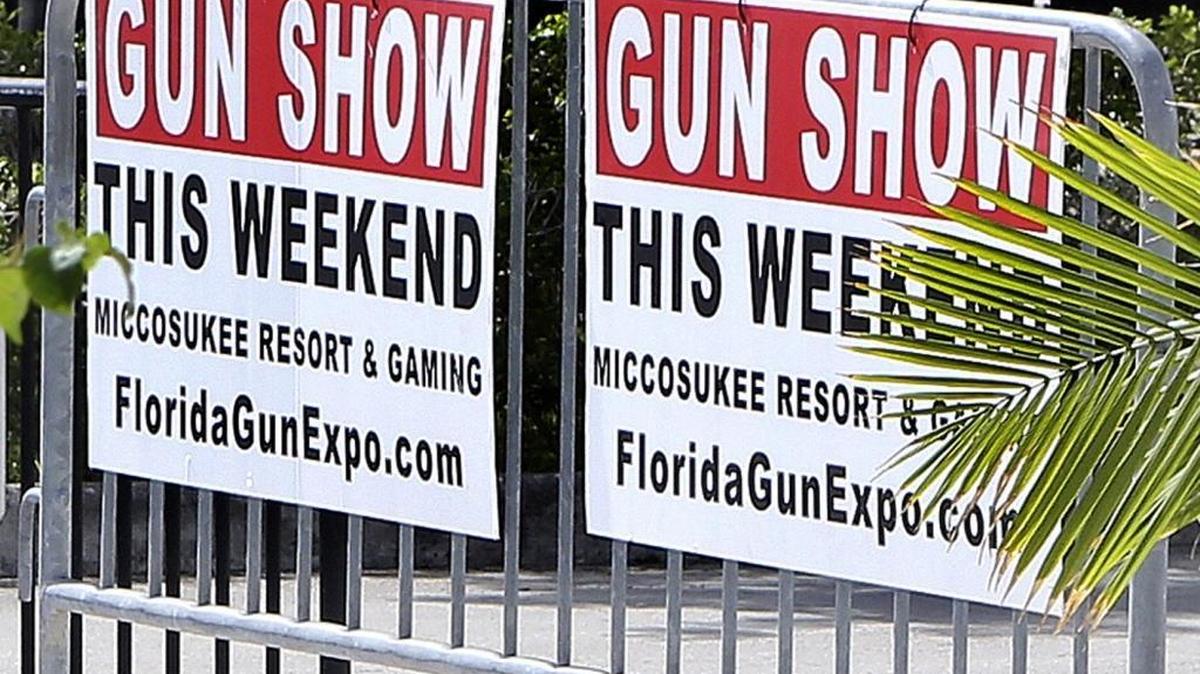 Signs for a weekend gun show are posted June 18, 2016, outside Miccosukee Resort & Gaming west of Miami. The gun show drew buyers and browsers nearly one week after Omar Mateen used a semiautomatic rifle to kill 49 people and wound scores of others inside the Pulse nightclub in Orlando.