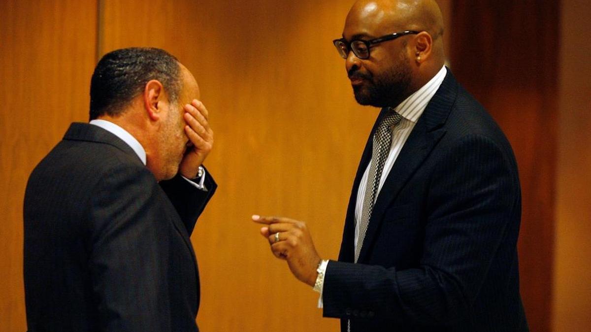 Lobbyist Ron Book reacts as he talks with Sen. Oscar Braynon, D-Miami Gardens, outside the Senate chamber, May 3, 2013, in Tallahassee. A bill sponsored by Braynon to give the Miami Dolphins a taxpayer-supported stadium upgrade was struggling on the final day of the legislative session.