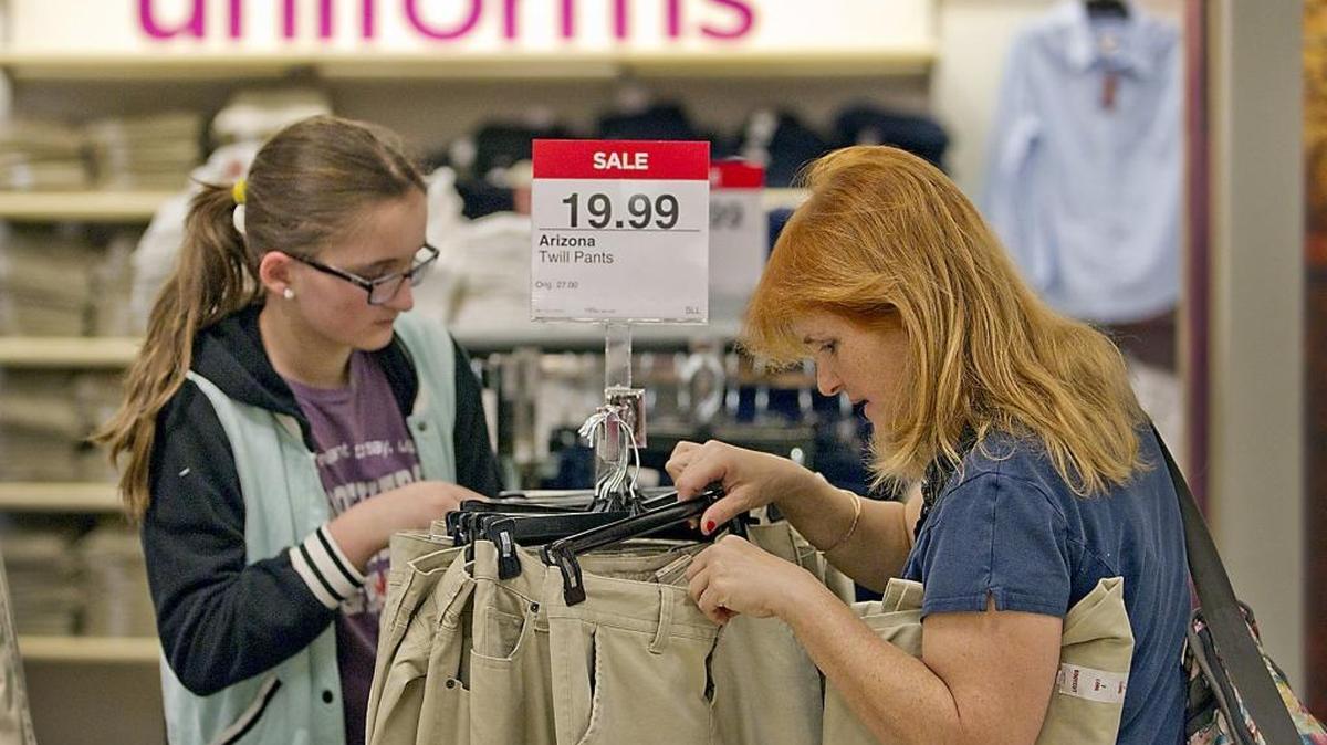Katherine Yanes, 12, left, a student at Carver Middle School and her mother Lissette search for her uniform size at the JC Penney store in the Dadeland Mall on Thursday August 1, 2013. They were out buying uniforms before that year’s sales tax holiday to beat the crowds and the possibly depleted stock.