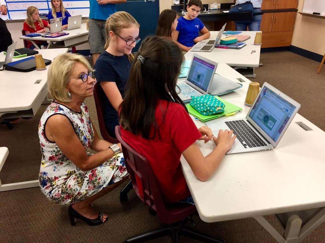 U.S. Education Secretary Betsy DeVos talks with sixth-grade students as they learn the fundamentals of email at Holy Comforter Episcopal School in Tallahassee on Tuesday, Aug. 29, 2017. DeVos spent two hours visiting classrooms at the private Christian school.