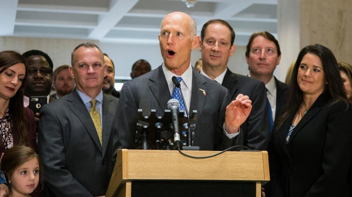 Gov. Rick Scott speaks after the end of the legislative session at the Capitol in Tallahassee on Sunday, March 11, 2018. Flanking Scott are Speaker of the House Richard Corcoran, left, and Senate President Joe Negron.