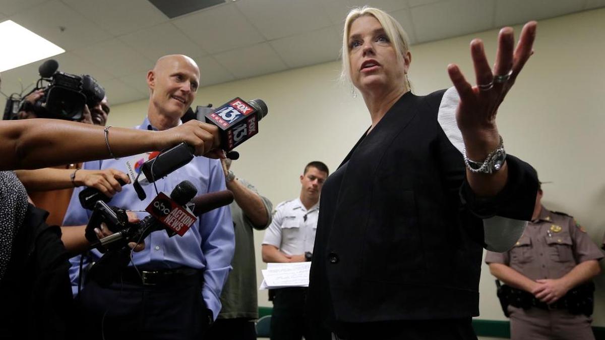 Florida Attorney General Pam Bondi, right, and Gov. Rick Scott thank first responders who assisted during Tropical Storm Colin in a visit to the Hillsborough County Sheriff's Office Tuesday, June 7, 2016, in Tampa. Bondi faces her own political storm over questions being raised about her soliciting campaign donations from Donald Trump at the same time her office was reviewing complaints against Trump University.