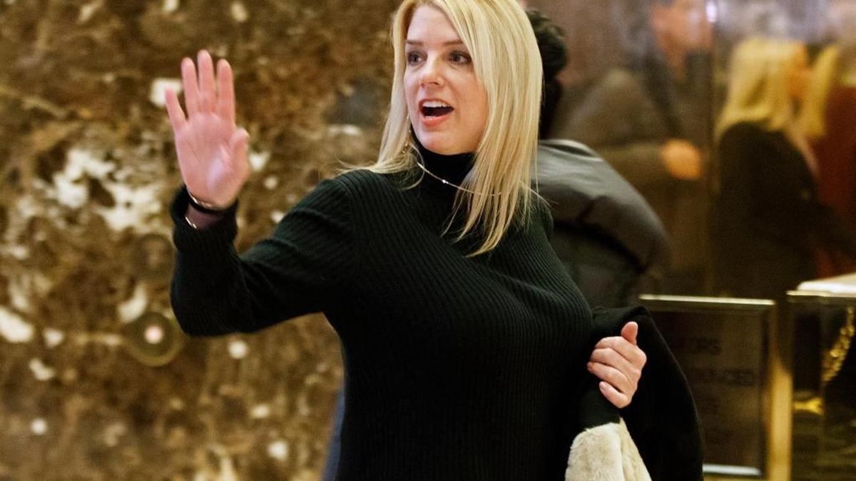 Florida Attorney General Pam Bondi waves to reporters as she arrives at Trump Tower to meet with President-elect Donald Trump, Friday, Dec. 2, 2016, in New York.