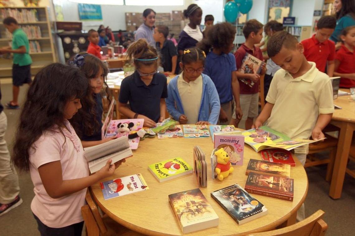 Student at South Miami Heights Elementary, look at books, Thursday, May 28, 2015, that Molina Healthcare of Florida, delivered along with 325 books as part of the Read to Succeed program.