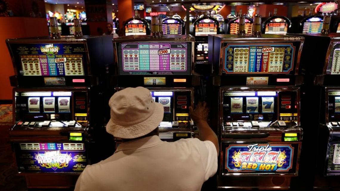 A man plays on a slot machine at the Magic City Casino in Miami, June 17, 2014.
