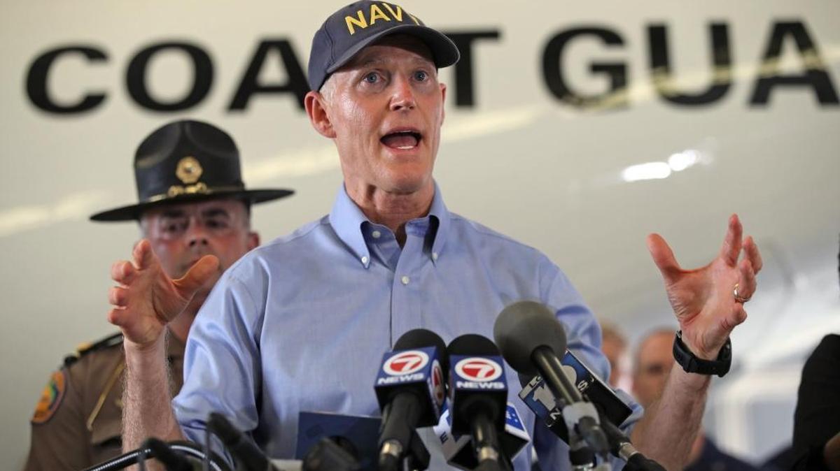 Florida Gov. Rick Scott speaks to reporters in Opa-locka the day after Hurricane Irma on Sept. 11.