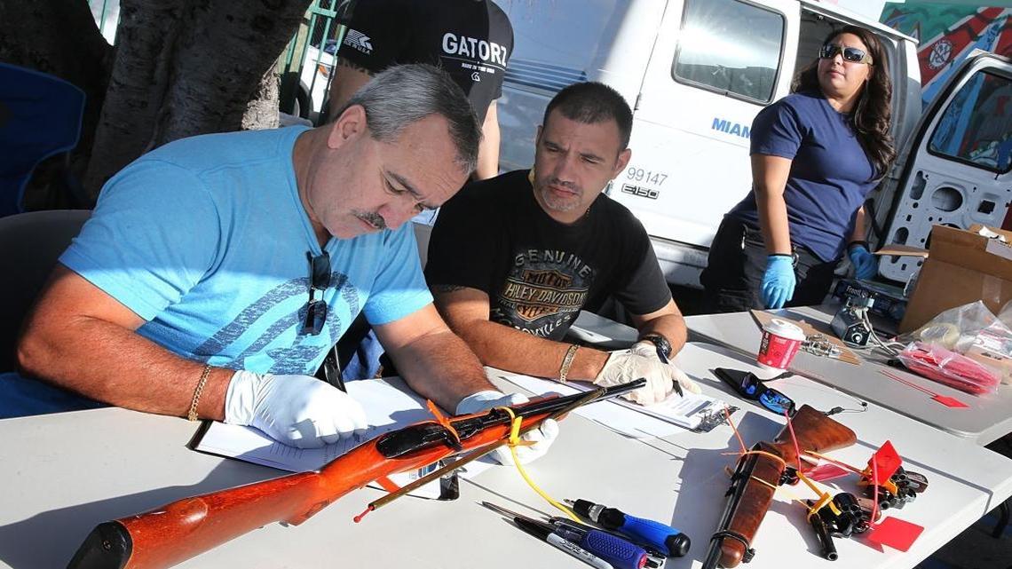 Miami Police detectives register guns collected from the public during a gun buy back event hosted by the department and the Rickia Isaac Foundation at Dorsey Park in Miami, December 17, 2016.