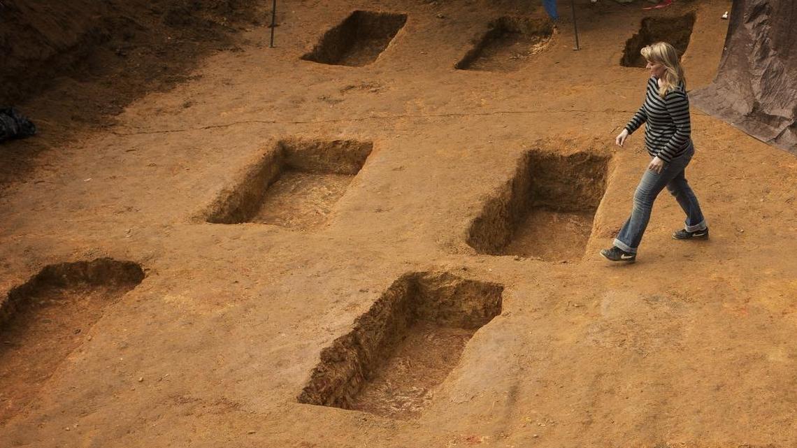 University of South Florida assistant professor of anthropology Dr. Erin Kimmerle passes open graves at the Boot Hill cemetery at the Arthur G. Dozier School for Boys, Dec. 20, 2013. Researchers from the University of South Florida have removed dozens of sets of human remains.