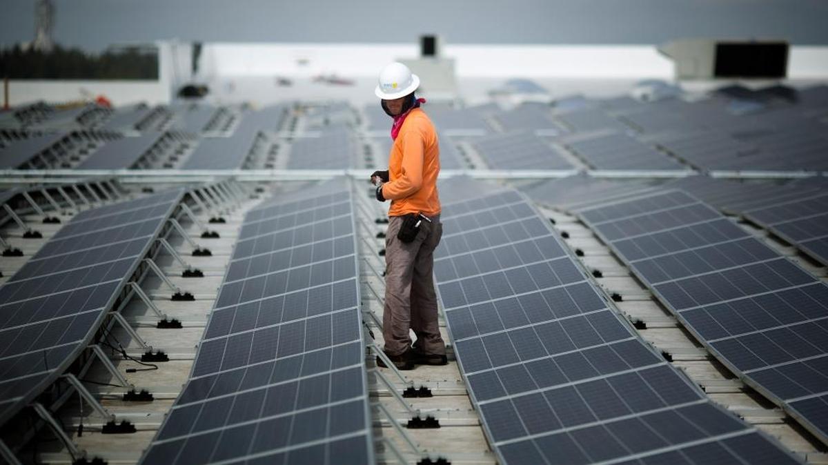 Neil Black works on the installation of South Florida’s largest solar panel array atop the IKEA store in Miami, April 16, 2014. This is Ikea's 40th solar-powered project in the U.S. The 178,000 square foot solar array consists of 4,620 panels.