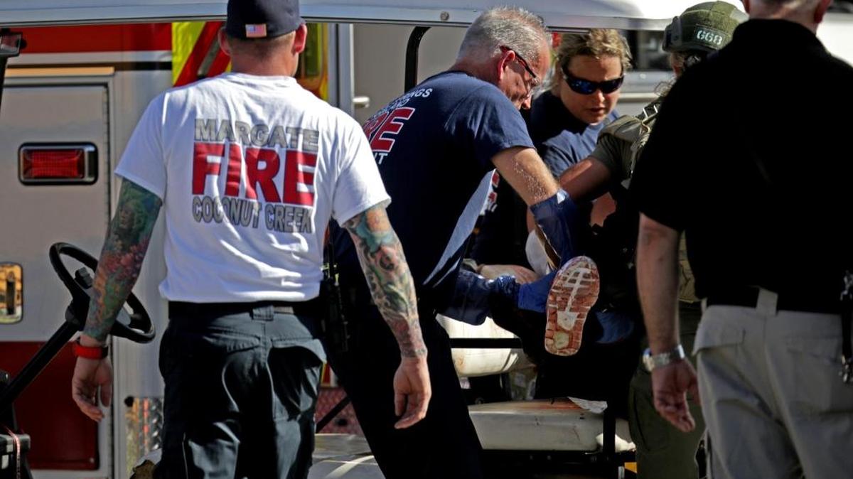 Medical personnel tend to a victim outside of Marjory Stoneman Douglas High School in Parkland on Wednesday, Feb. 14, 2018.
