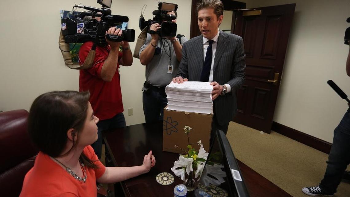 Colin Tooze, Uber’s director of public affairs, center, delivers 32,500 signatures from an on-line petition to Florida Senate President Andy Gardiner’s office in the Florida Capitol, Thursday, March 10, 2016, in support of an Uber bill.