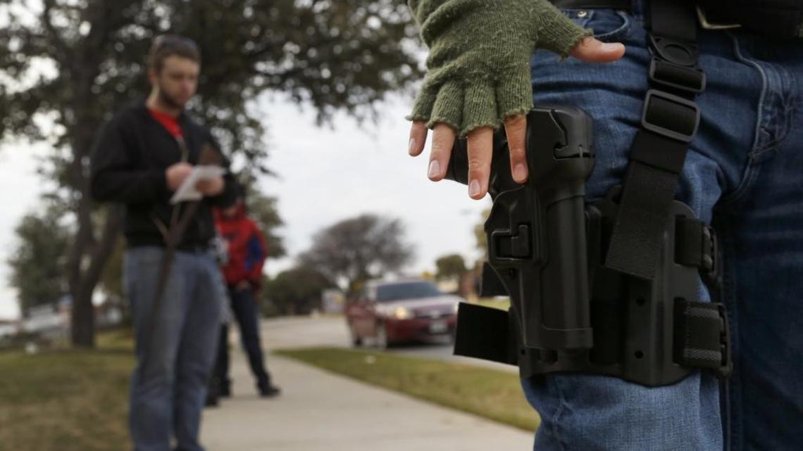 Luis Mises with his S&P military police hand gun in a belt holster on his leg joins fellow activists during an Open Carry Walk in Arlington, Texas, on Jan. 1, 2016.