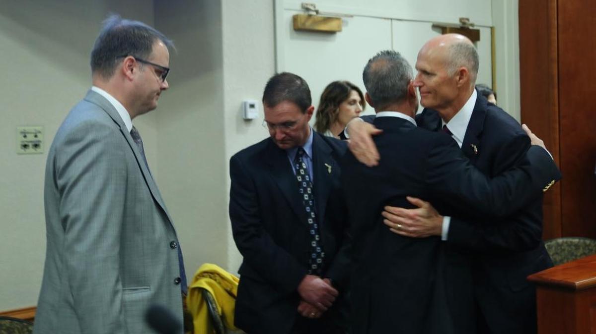 Gov. Rick Scott hugs Andrew Pollack, whose daughter Meadow Pollack was killed in the Marjory Stoneman Douglas High School shooting in Parkland. At left is Ryan Petty, whose daughter Alaina Petty was also killed. Scott greeted the Parkland parents during a Florida Cabinet meeting at the Capitol on Thursday.