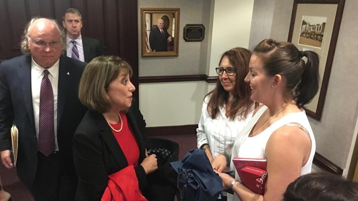 Connie Rose, left, a survivor of human trafficking, speaks to another survivor, Linsey Ruth, on Monday at the Florida Capitol in Tallahassee, where a bill was being heard that would allow victims to sue their traffickers and the businesses that turn a blind eye to trafficking.