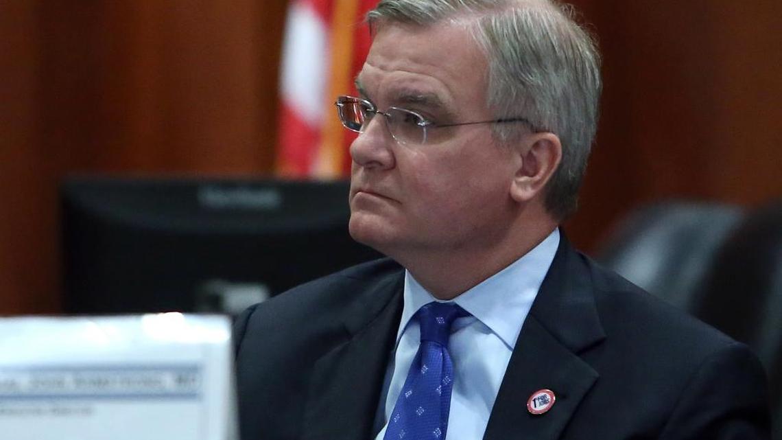 Florida Surgeon General Dr. John Armstrong listens to Sen. Don Gaetz, R-Niceville, as Gaetz comments at the Commission on Health Care and Hospital Funding meeting, Jan. 19, 2016, in Tallahassee.