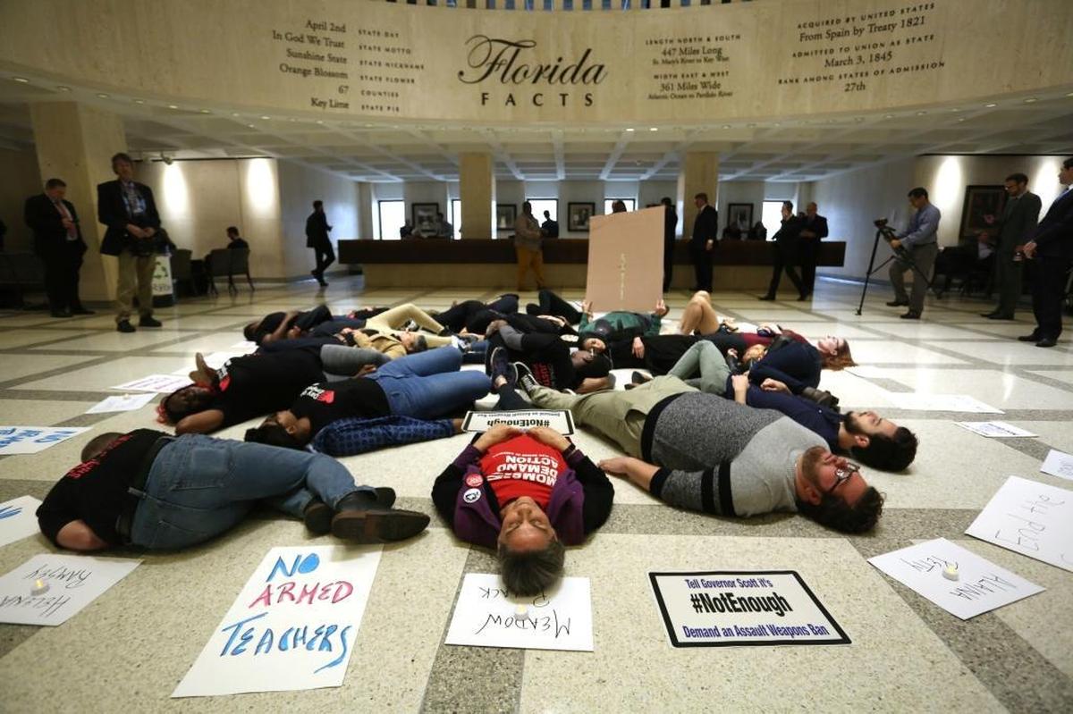 About 20 protesters participate in a “die-in” on the fourth floor rotunda of the Florida Capitol in Tallahassee on Tuesday, March 6, 2018, as they continue to push for an assault weapons ban.