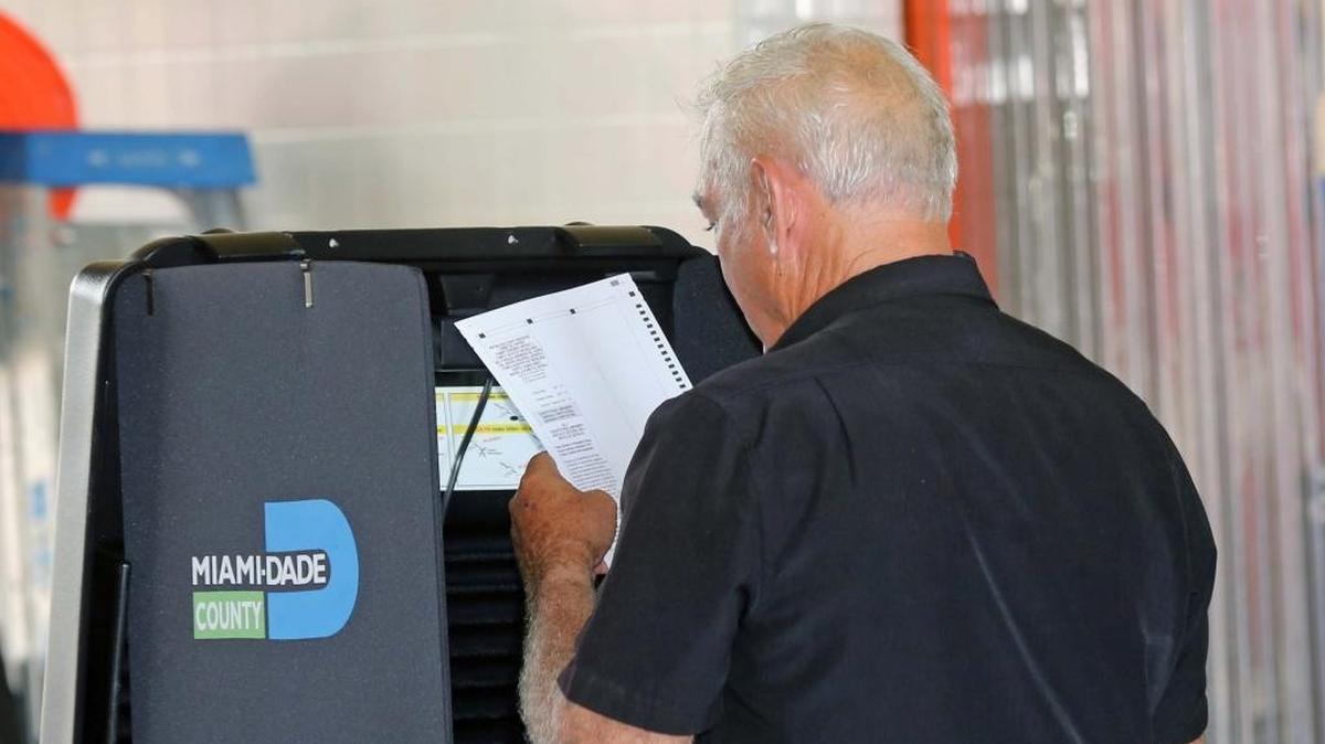 A Hialeah voter double checks his ballot before submitting it on Tuesday, August 30, 2016.