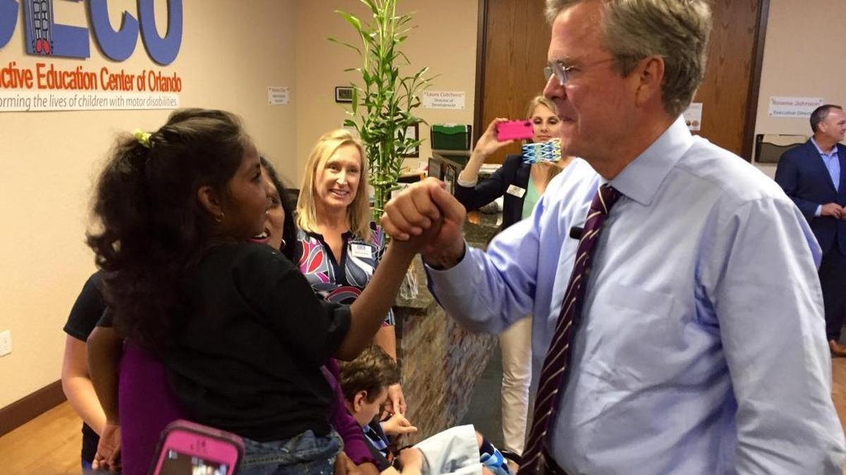 Republican presidential contender and former Gov. Jeb Bush meets parents and children as he arrives at the Conductive Education Center of Orlando in Winter Park, Fla., during a campaign stop Monday, Nov. 2, 2015.