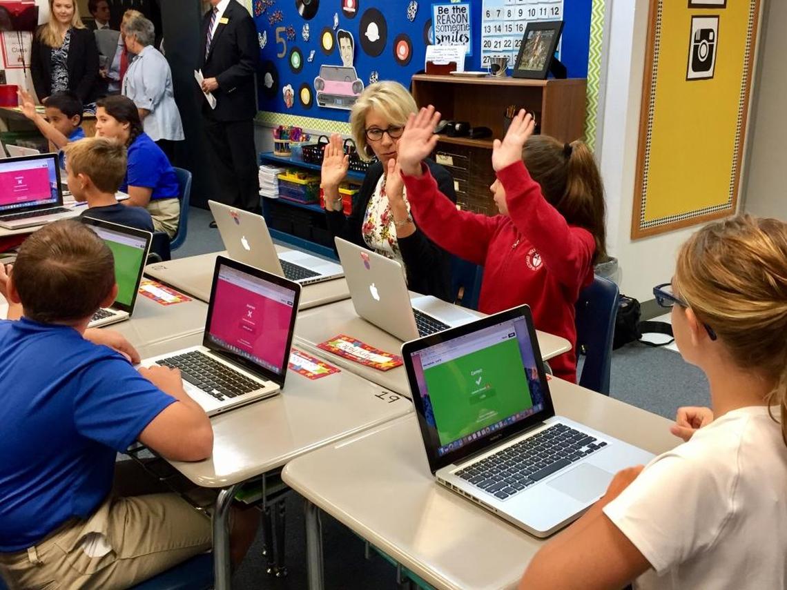 U.S. Education Secretary Betsy DeVos participates in a lesson with fifth grade students at Holy Comforter Episcopal School in Tallahassee on Tuesday, Aug. 29, 2017, as they use an online-learning platform to take a quiz about idioms. DeVos spent two hours visiting classrooms at the private Christian school.