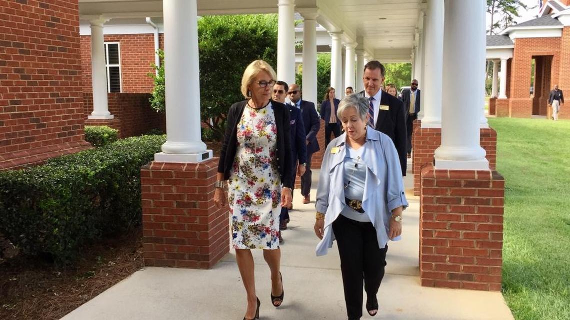 U.S. Education Secretary Betsy DeVos, left, talks with Nena Martinez, director of admissions at Holy Comforter Episcopal School in Tallahassee, after DeVos arrived for a school tour on Tuesday, Aug. 29, 2017. DeVos spent two hours visiting classrooms at the private Christian school.