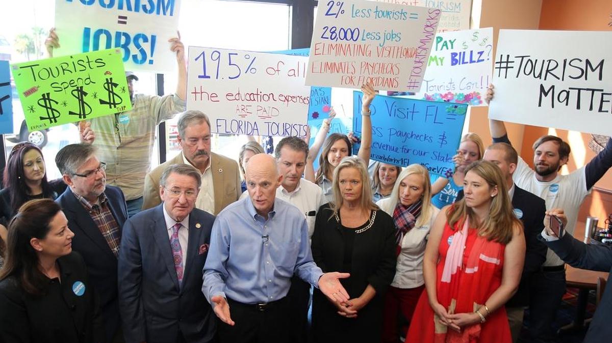 Area business leaders and workers gather around Florida Gov. Rick Scott after a roundtable discussion about the local economic impact of VISIT FLORIDA and Enterprise Florida in Panama City Beach.