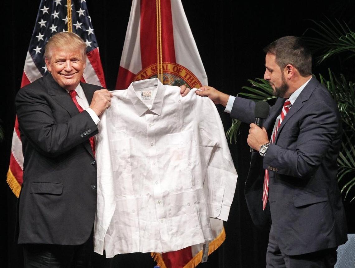 Then-candidate Donald Trump receives a classic linen guayabera from state Rep. Carlos Trujillo in September.