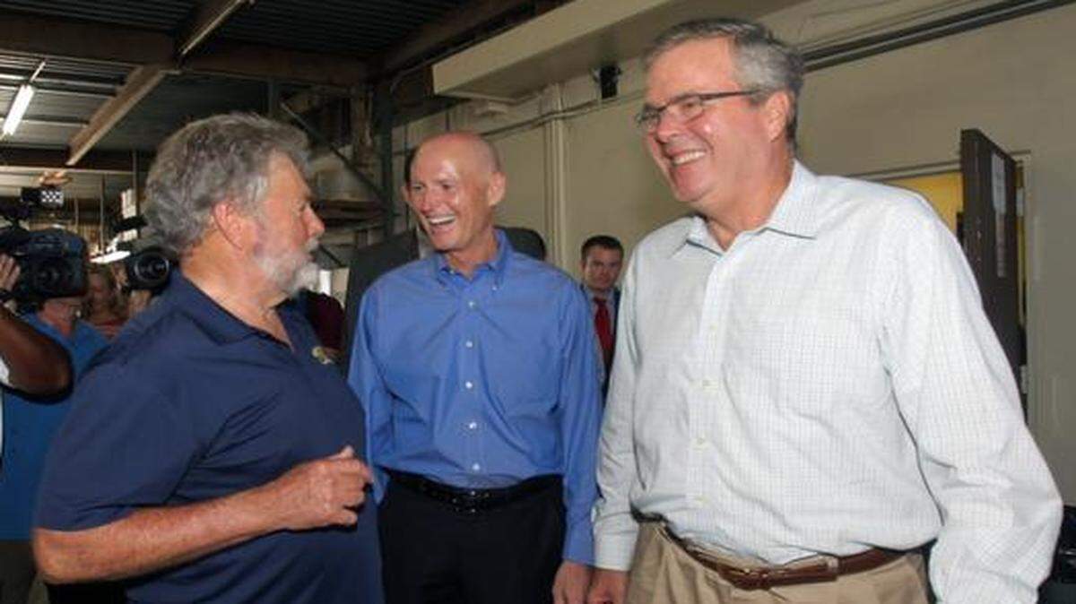 
FILE--From left: William E. Berzowski, President of BK Installations; Florida Gov. Rick Scott and former Florida Gov. Jeb Bush enjoy a light moment during a campaign event Friday, Aug. 15, 2014.
