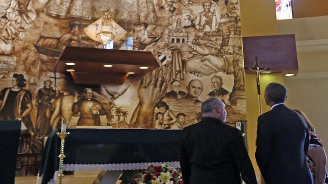 
President Barack Obama admires the mural depicting Our Lady of Charity at the Coconut Grove shrine.

