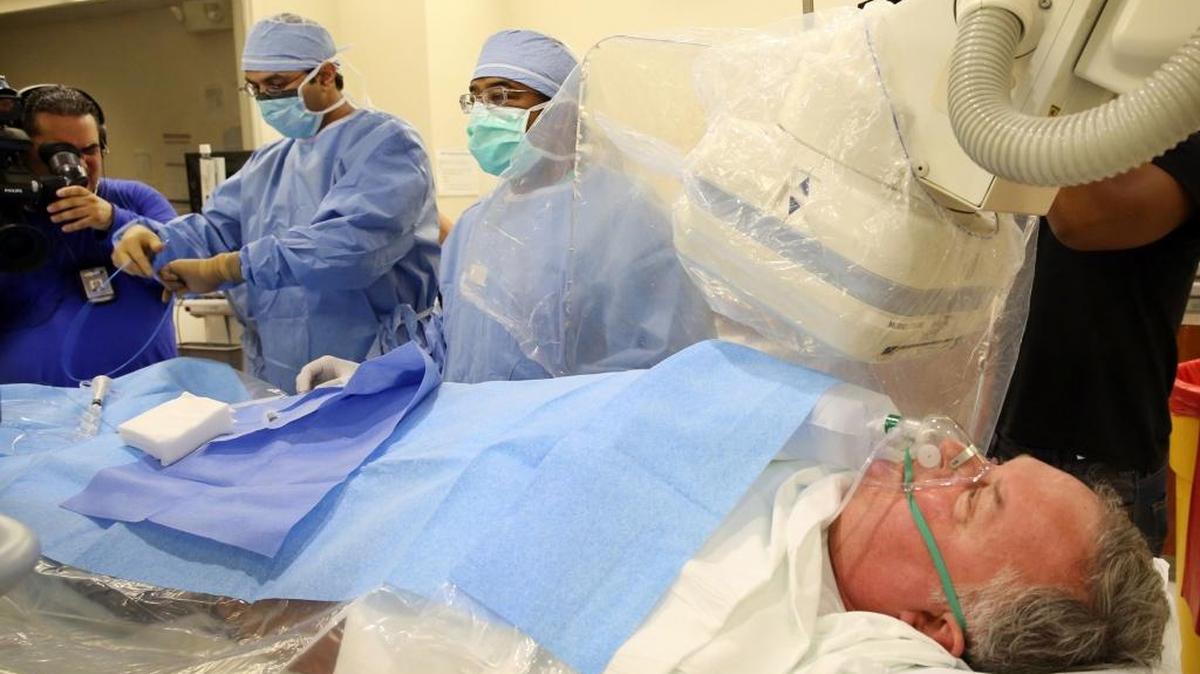 Dr, Kanna Posina, left works with Dr. Nirat Beohar, the director of Mount Sinai’s cardiac catheterization lab and structural heart disease program, on a practice procedure on pretend patient, David Patlak, during an emergency drill in July 2015.