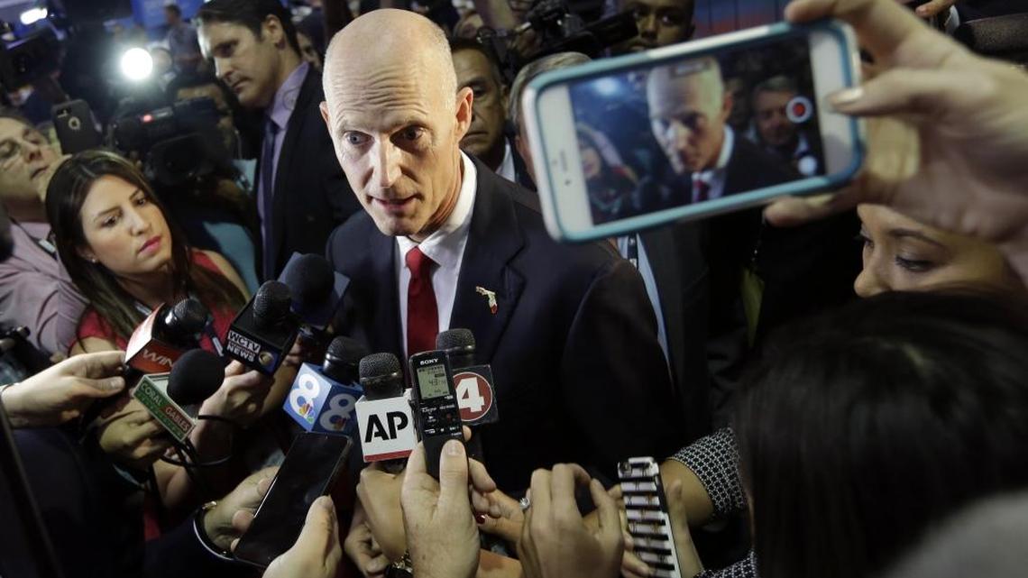 Florida Gov. Rick Scott speaks in the spin room before the Republican presidential debate at the University of Miami, Thursday, March 10, 2016, in Coral Gables.