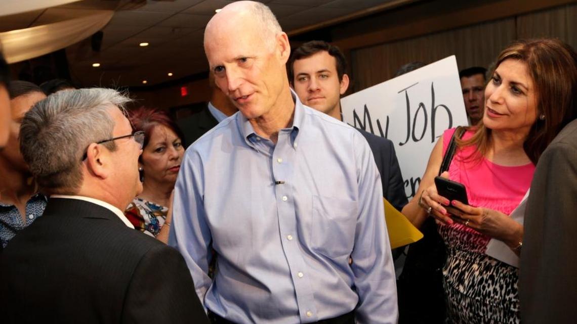 Florida Gov. Rick Scott speaks with people following a jobs roundtable about the economic impact of Visit Florida and Enterprise Florida, Thursday, March 2, 2017, in Hialeah.