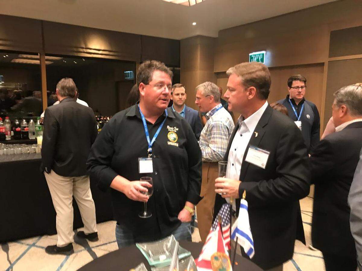 Florida Rep. Randy Fine talks with FPL President Eric Silagy during a meet-and-greet session at the Hilton Tel Aviv after the Florida delegation touched down for a four-day trade mission to Israel.