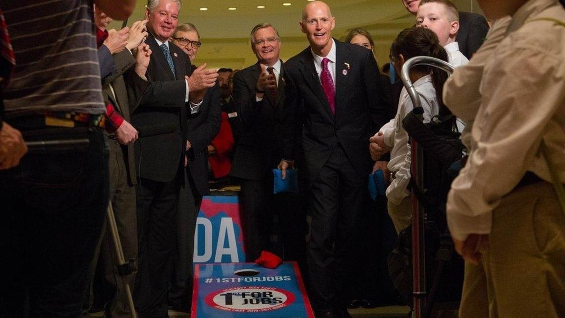 Gov. Rick Scott kicks off his jobs public-relations tour with a game of corn hole at the Capitol, where he asked others to lobby lawmakers for him.