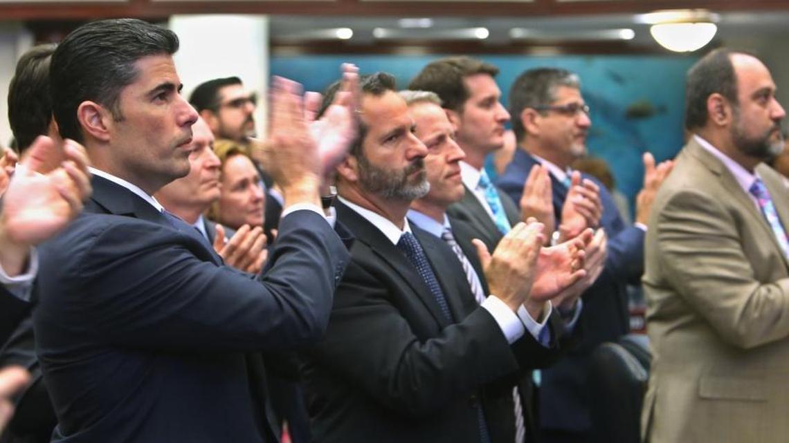 Rep. Jose Oliva, R-Miami Lakes, left, and other members of the Florida House applaud Marjory Stoneman Douglas High School parent Andrew Pollack, whose daughter, Meadow Pollack, was killed in the school shooting. The House passed the gun and school safety bill Wednesday, March 7, 2018.
