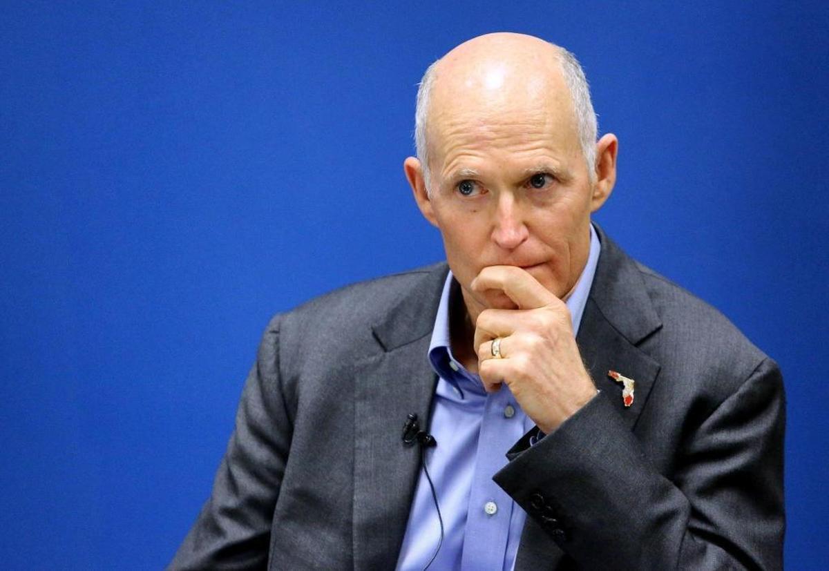 Gov. Rick Scott listens during a roundtable discussion in Kissimmee in November 2017 about the influx to the Orlando area of Puerto Rico residents affected by Hurricane Maria.