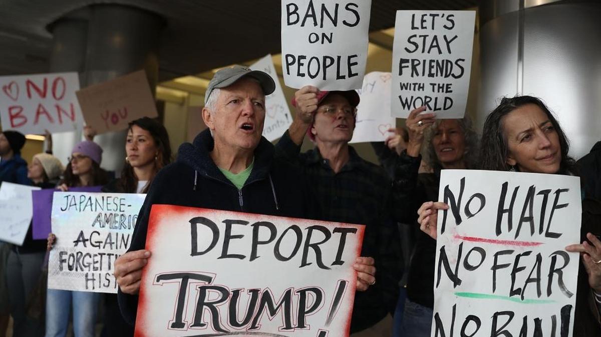 Protesters stand together at the Miami International Airport against the executive order that President Donald Trump signed clamping down on refugee admissions and temporarily restricting travelers from seven predominantly Muslim countries on January 29, 2017 in Miami.