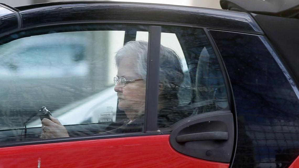 A driver texts as she makes her way through traffic in Dallas on March 6, 2017.
