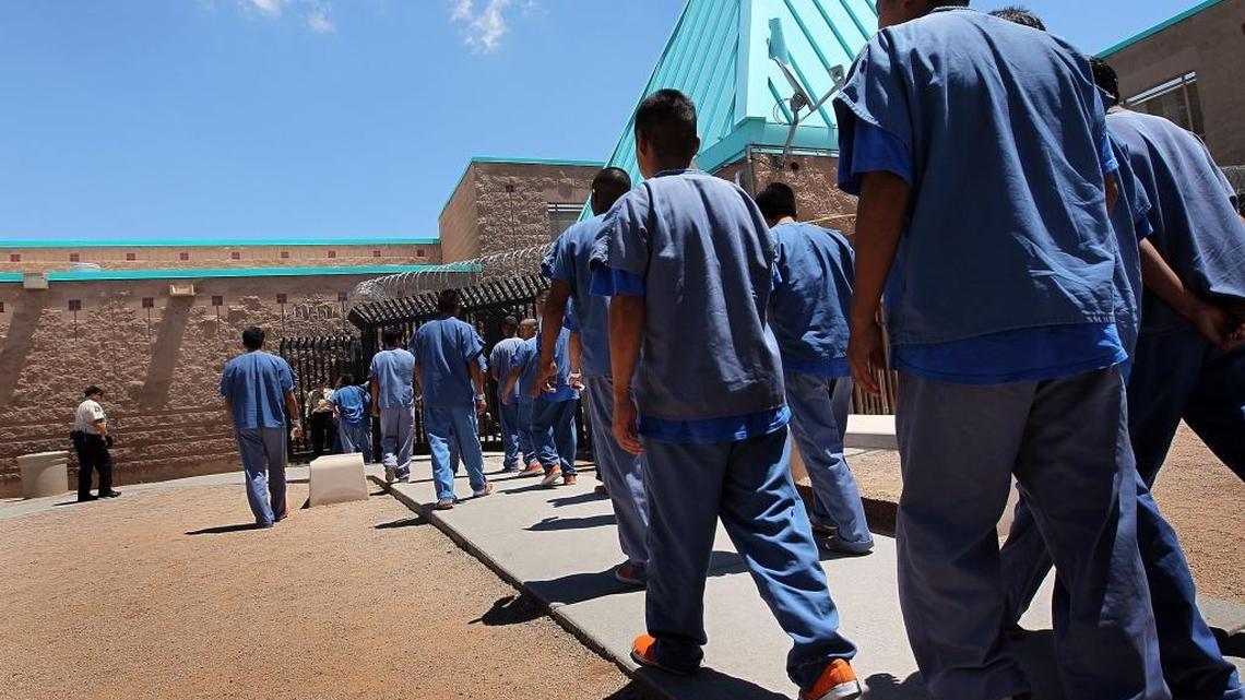 Detained immigrants walk back to their housing units following lunch at the U.S. Immigration and Customs Enforcement (ICE) detention facility on July 30, 2010 in Florence, Arizona. Most immigrants at the center are awaiting deportation or removal and return to their home countries, while some are interned at the facility while their immigration cases are being reviewed.