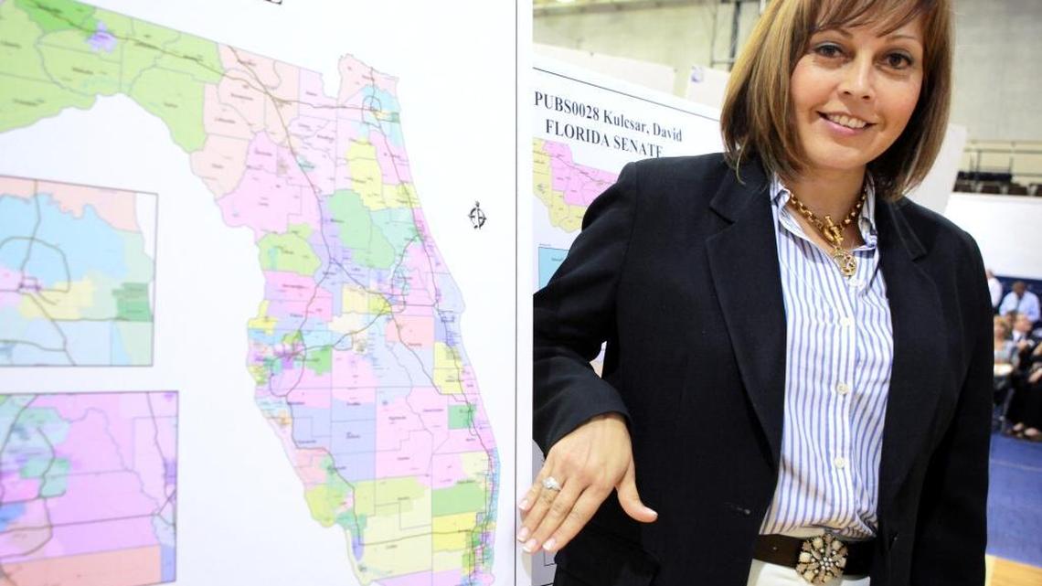Margaret Delmont looks over a congressional district map during a redistricting hearing at Broward College on August 16, 2011.