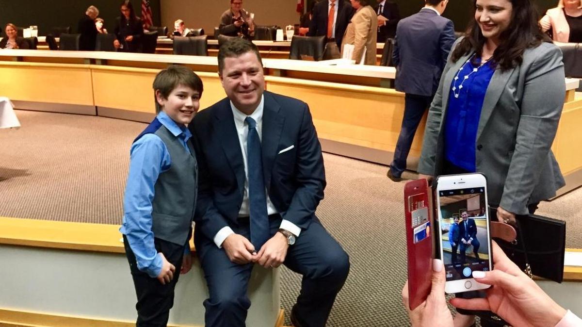 Ethan Greenberg, a sixth-grader at Silver Trail Middle School in Pembroke Pines, poses for a photo with state Sen. Jeff Brandes, R-St. Petersburg, while his mom, Ryann, looks on after a Senate Education Committee meeting Monday in Tallahassee. Ethan and Ryann Greenberg spoke in favor of Brandes’ proposal to make computer coding count as a foreign language for Florida high school students.