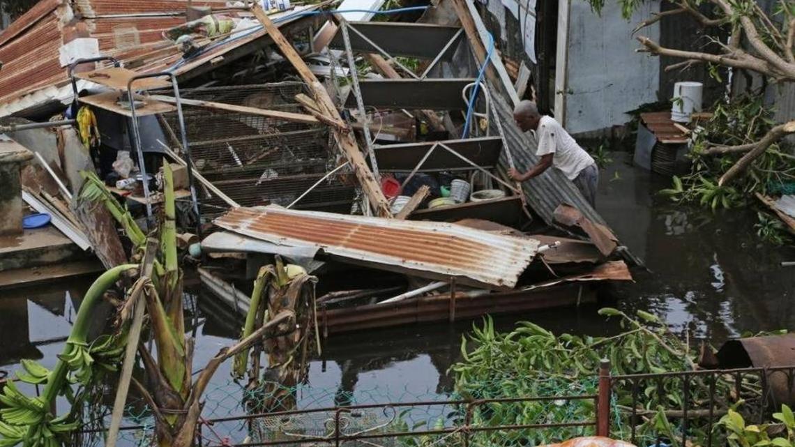 Farmer Victor Lozada searches for items that can be salvage from his shed in Puerto Rico that was completely destroyed by Hurricane Maria on Friday, September 22, 2017.