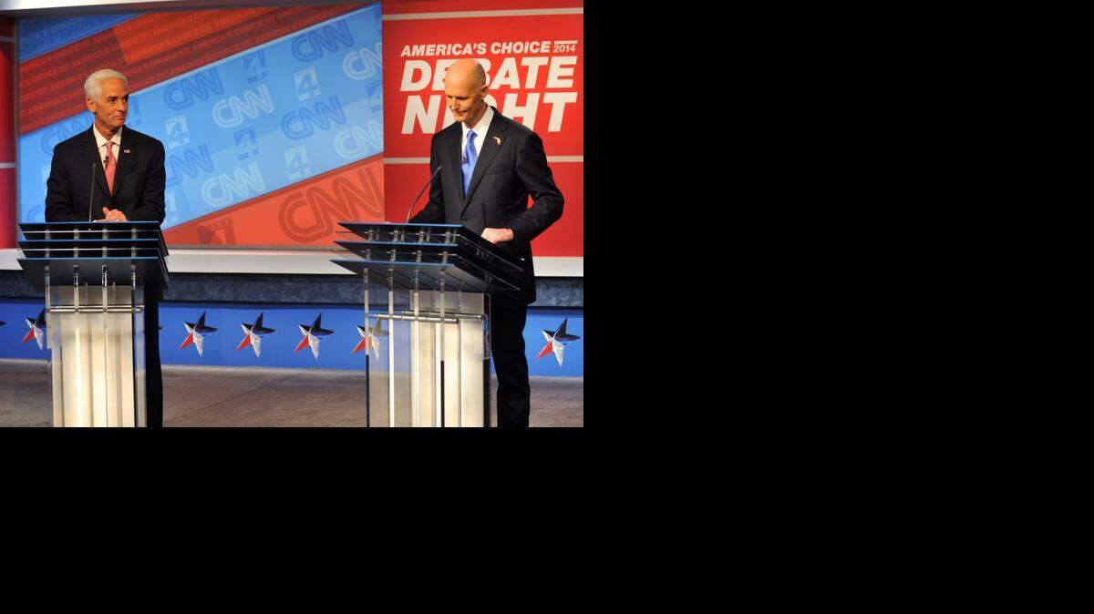 
Democratic candidate Charlie Crist, left, and Republican Gov. Rick Scott wait for their live televised debate, Tuesday, Oct. 21, 2014 hosted by WJXT-TV and CNN at the Channel 4 studios in Jacksonville.
