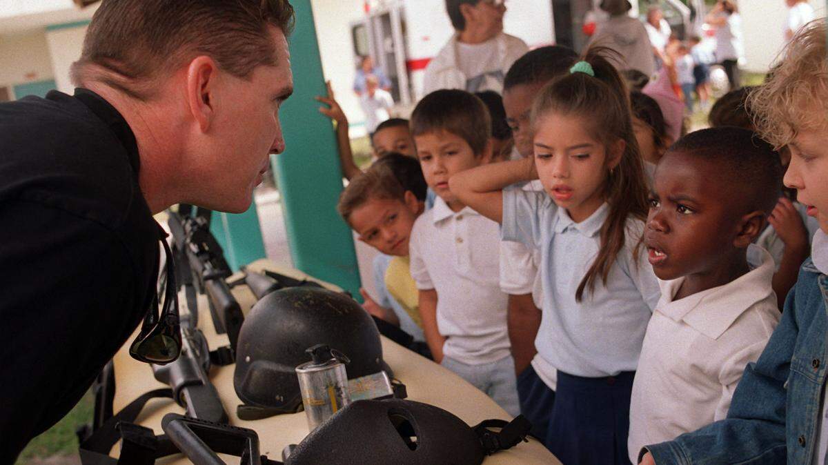 Members of the Hialeah Police Department’s SWAT team talk to students at Amelia Earhart Elementary School in Hialeah about gun safety and to let kids know that “guns are not cool.”