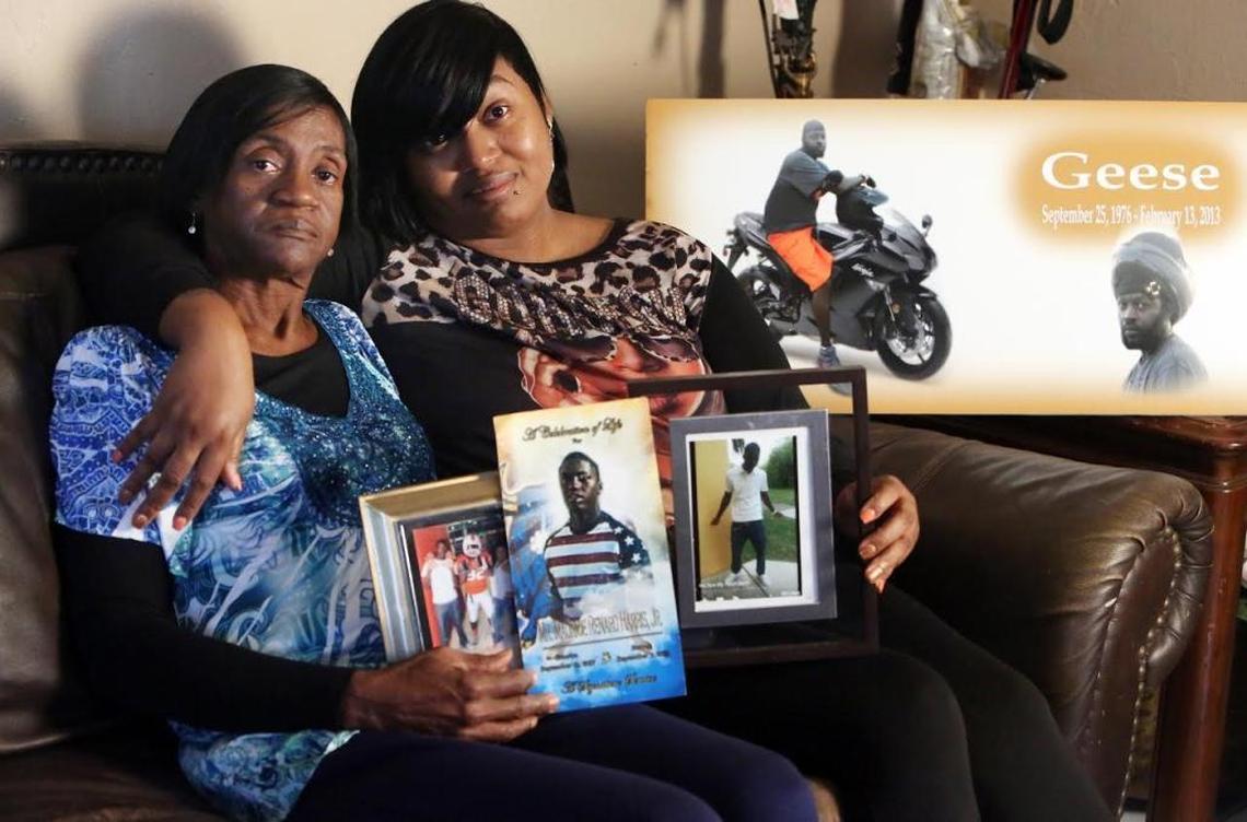 Annie Steeter, grandmother of Maurice Harris Jr., and her daughter, Shakila Stewart, share photos and a program from Maurice’s funeral service. On the table beside them is a memorial to Maurice’s father, Maurice Harris Sr., who was slain during a home invasion robbery.