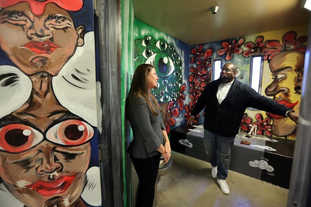 Department of Juvenile Justice Secretary Christina K. Daly tours the once deeply troubled Palm Beach Youth Academy, which has a new operator and new programs, including an art program reflected in the walls.