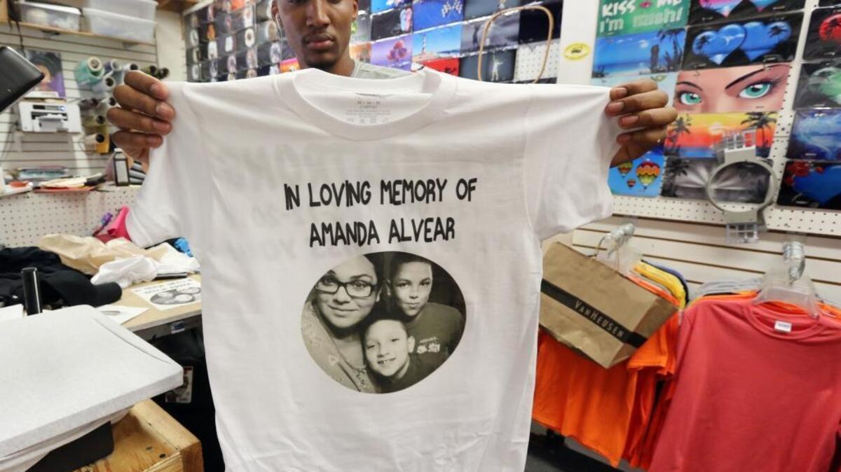Drew Malcolm pulls a memorial t-shirt for Pulse shooting victim Amanda Alvear, 22, off the press at Custom Signs and Embroidery at the Main Gate Flea Market in Kissimmee on Thursday afternoon, June 16, 2016. Malcolm said he made approximately 200 memorial shirts for the families of four of the victims on Thursday.