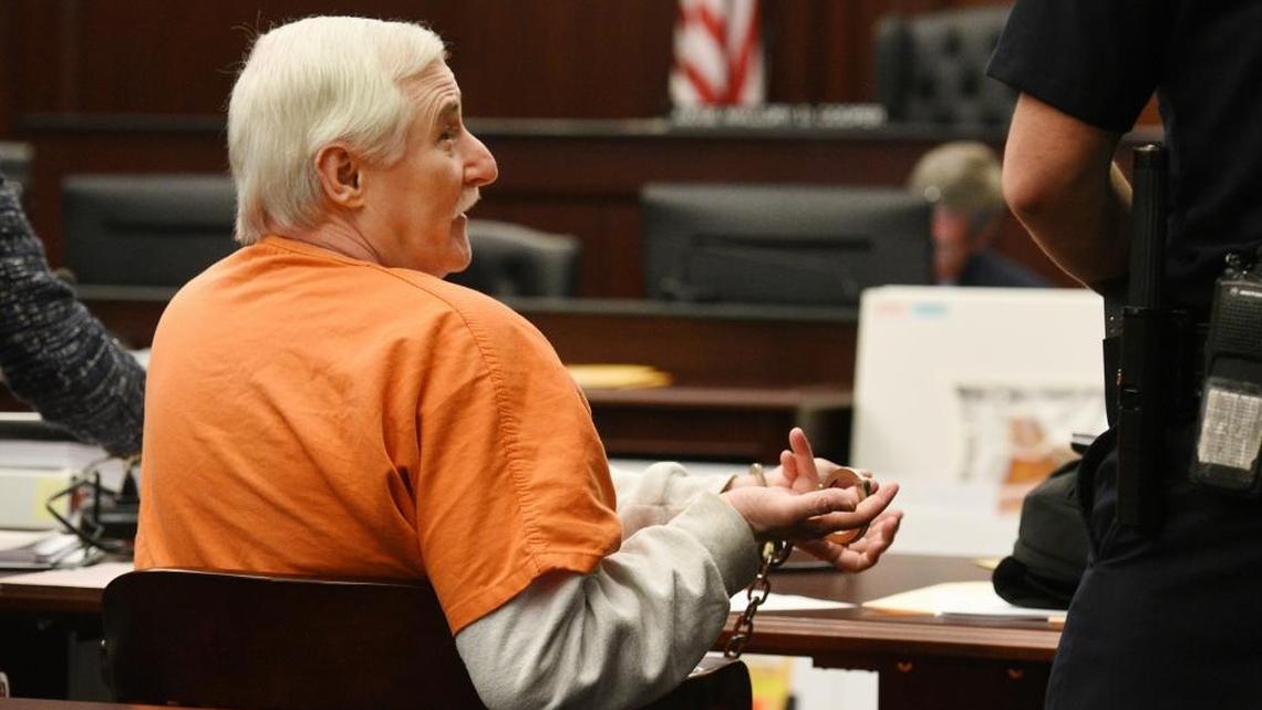 Donald Smith presents his handcuffs to be unlocked by a bailiff so he can sign paperwork early in Tuesday’s court proceedings on Feb. 20, 2018, in the courtroom of Judge Mallory Cooper in Jacksonville, Florida. After being found guilty in the kidnapping, rape and murder of 8-year-old Cherish Perrywinkle, the trial of Smith continued with a death penalty decision by the jury on Feb. 22.