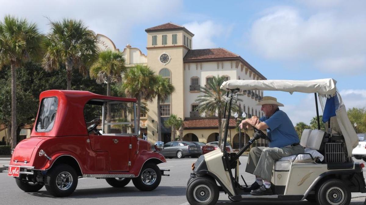 In this Sept. 21, 2008 file photo, William LeBeau, 86, right, sits in his golf cart in a parking spot at the main square in The Villages, Fla. New U.S. Census estimates show that the retirement mecca of The Villages was the fastest-growing metro area in the United States.